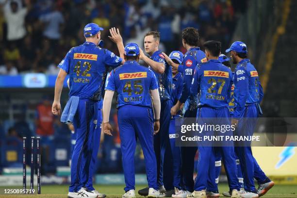 Mumbai Indians' Jason Behrendorff celebrates with teammates after taking the wicket of Chennai Super Kings' Devon Conway during the Indian Premier...