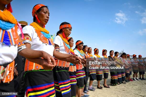 The Konyak tribe's women dance at their community gathering in Longwa village, in the northeast Indian state of Nagaland on April 8, 2023.