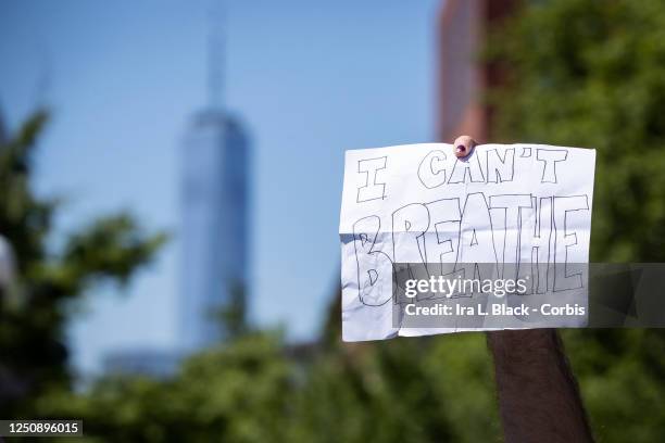 Protester holds a sign that says, "I Can't Breathe" with One World Trade Center behind them in Washington Square Park. This was one of the peaceful...