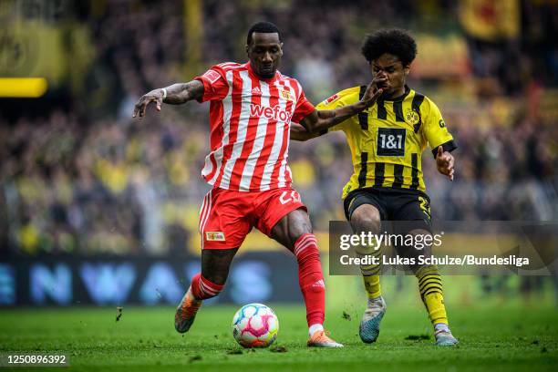 Sheraldo Becker of Berlin and Karim Adeyemi of Dortmund in action during the Bundesliga match between Borussia Dortmund and 1. FC Union Berlin at...