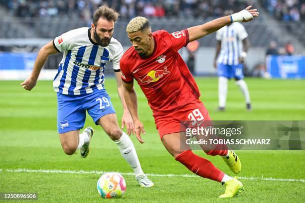 Leipzig's German defender Benjamin Henrichs and Hertha Berlin's French midfielder Lucas Tousart vie for the ball during the German first division...