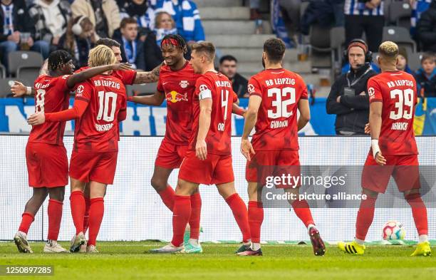 April 2023, Berlin: Soccer: Bundesliga, Hertha BSC - RB Leipzig, Matchday 27, Olympiastadion. RB Leipzig's Mohamed Simakan celebrates with teammates...