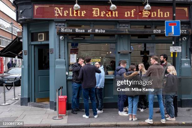 Drinkers enjoying a pint outside the Nellie Dean pub on Dean Street in Soho on 30th March 2023 in London, United Kingdom. The Nellie Dean is a public...