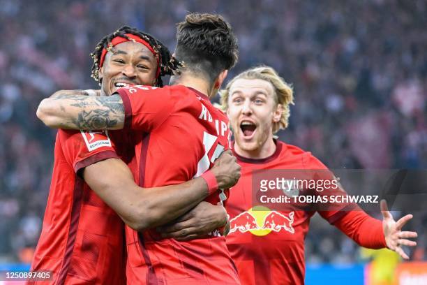 Leipzig's French defender Mohamed Simakan celebrates scoring the opening goal with his teammates during the German first division Bundesliga football...