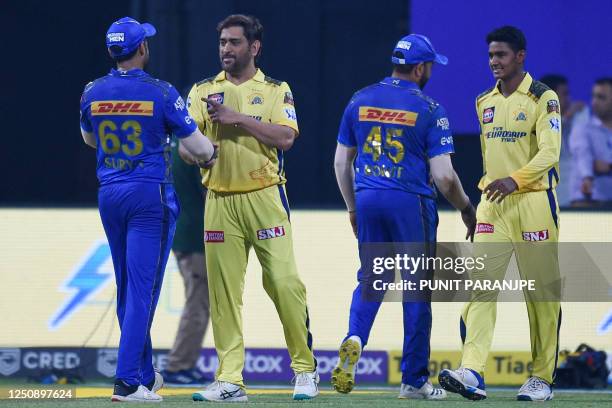 Chennai Super Kings' captain Mahendra Singh Dhoni greets Mumbai Indians' Suryakumar Yadav at the end of the Indian Premier League Twenty20 cricket...