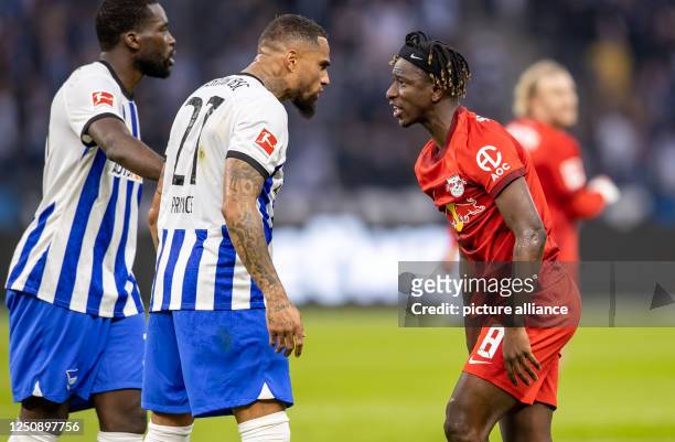 April 2023, Berlin: Soccer: Bundesliga, Hertha BSC - RB Leipzig, Matchday 27, Olympiastadion. Berlin's Kevin-Prince Boateng and RB Leipzig's Amadou...