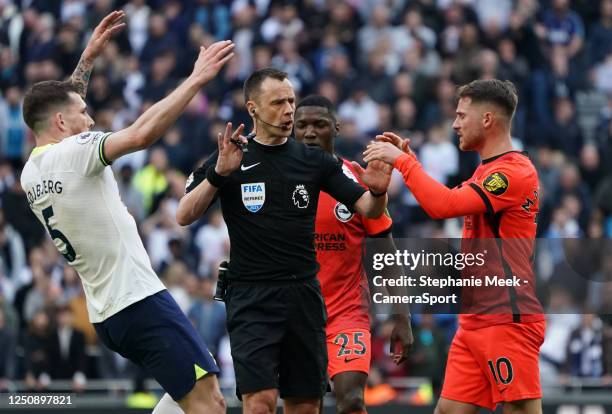 Referee Stuart Attwell tries to calm things down between Tottenham Hotspur's Pierre-Emile Hojbjerg and Brighton & Hove Albion's Alexis Mac Allister...