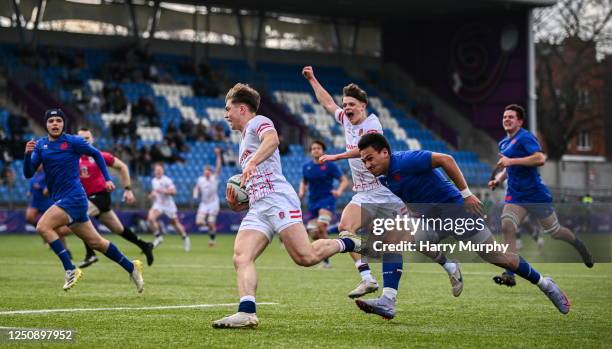 Dublin , Ireland - 8 April 2023; Jack Bracken of England evades the tackle of Kalvin Gourgues of France on his way to scoring his side's first try...