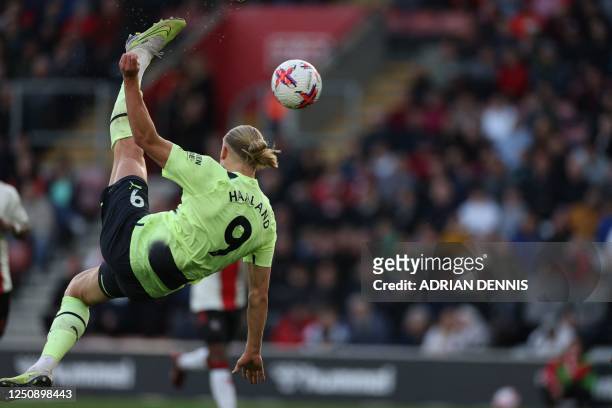 Manchester City's Norwegian striker Erling Haaland scores their third goal with this overhead kick during the English Premier League football match...