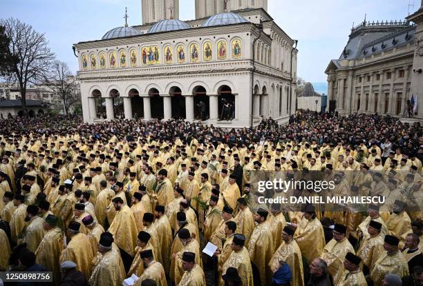 Romanian Christian Orthodox priests and believers listen to the speech of Patriarch Daniel of Romania at the Romanian Patriarchy Cathedral after the...