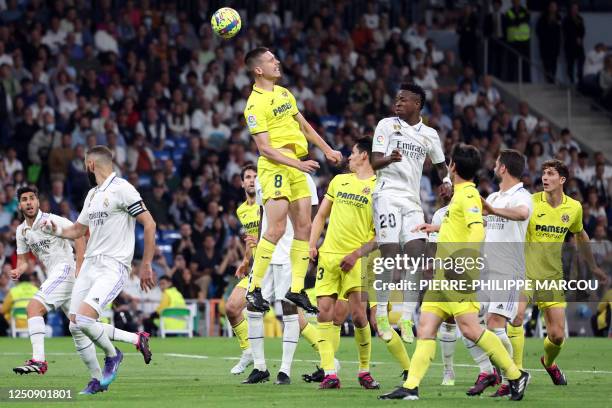 Villarreal's Argentinian defender Juan Foyth wins a header over Real Madrid's Brazilian forward Vinicius Junior during the Spanish league football...