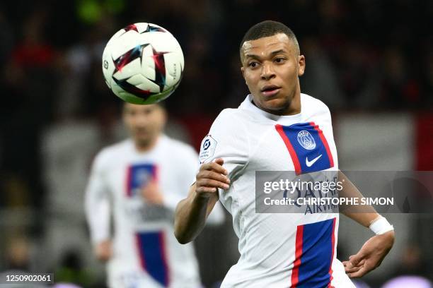 Paris Saint-Germain's French forward Kylian Mbappe looks at the ball during the French L1 football match between Nice and Paris Saint-Germain at the...