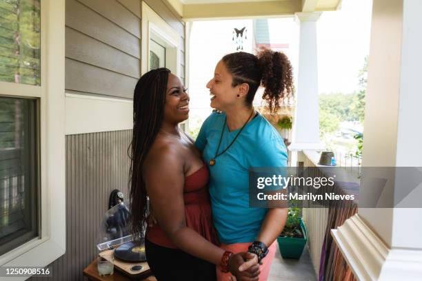lesbian couple at home dancing in celebration - black lesbians kiss stock pictures, royalty-free photos & images
