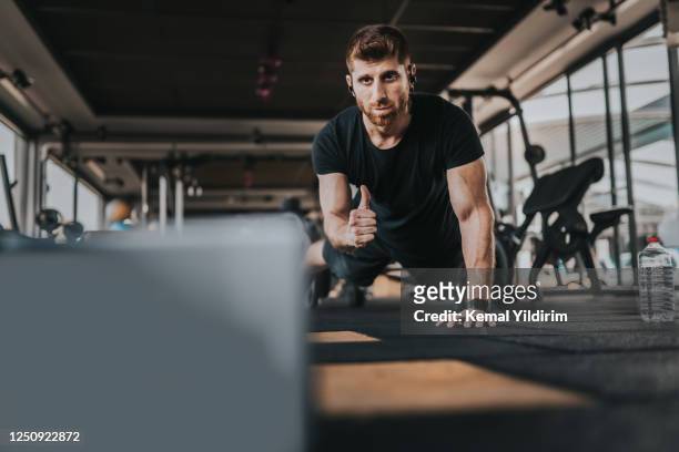 personal trainer giving online streaming during new-normal - coach stock pictures, royalty-free photos & images