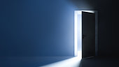 Bright light behind the slightly ajar door. Abstract background.
