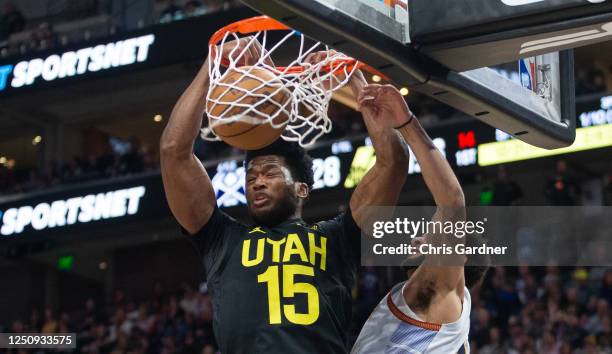 Damian Jones of the Utah Jazz slam dunks over Jamal Murray of the Denver Nuggets during the first half of their game April 8, 2023 at the Vivint...