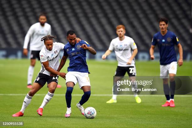 Bobby Decordova-Reid of Fulham tackles Rico Henry of Brentford during the Sky Bet Championship match between Fulham and Brentford at Craven Cottage...