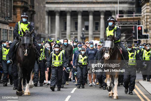 Group are escorted by police as they leave after attending a Black Lives Matter demonstration in George Square on June 20, 2020 in Glasgow, Scotland....