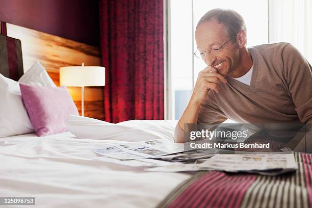 man looking at tear sheets. - newspaper tear stock pictures, royalty-free photos & images