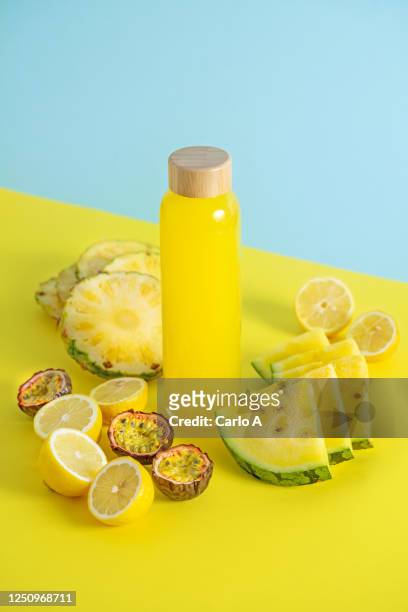 yellow fruits smoothie in a glass bottle - passion fruit imagens e fotografias de stock