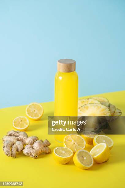 yellow fruits juice in a glass bottle - ショウガ ストックフォトと画像