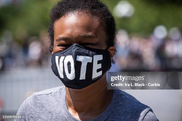 Dawn Smalls wears a mask that says, "Vote" in Washington Square Park expressing the sentiment that voting in November 2020 will be a way to help...