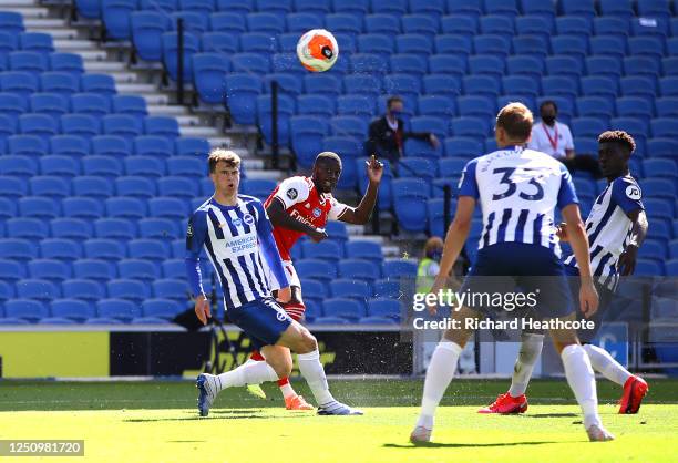 Nicolas Pepe of Arsenal scores his team's first goal past Matthew Ryan of Brighton and Hove Albion during the Premier League match between Brighton &...