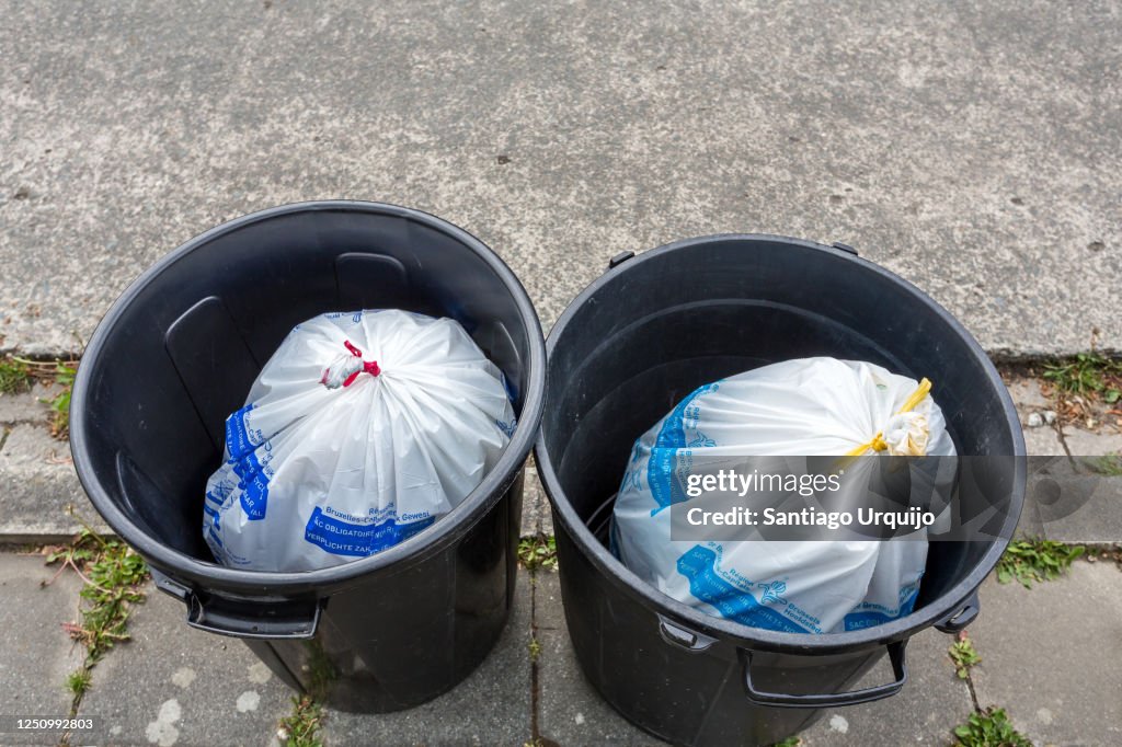 Rubbish bins filled with waste bags