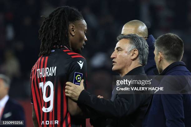 Paris Saint-Germain's French head coach Christophe Galtier speaks with Nice's French midfielder Khephren Thuram at the end of the French L1 football...