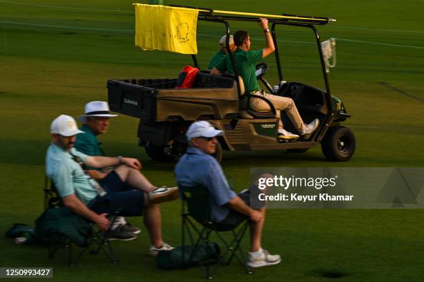 Agronomy staff collect pinflags as play wraps up during the first round of the 2023 Masters Tournament at Augusta National Golf Club on April 6 in...