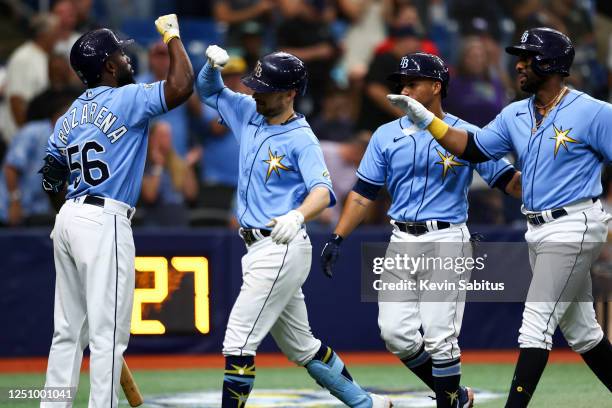 Brandon Lowe of the Tampa Bay Rays celebrates with Randy Arozarena after hitting a home run during the sixth inning against the Oakland Athletics at...