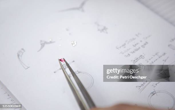 a jewelry designer sketching a new design. - joia imagens e fotografias de stock