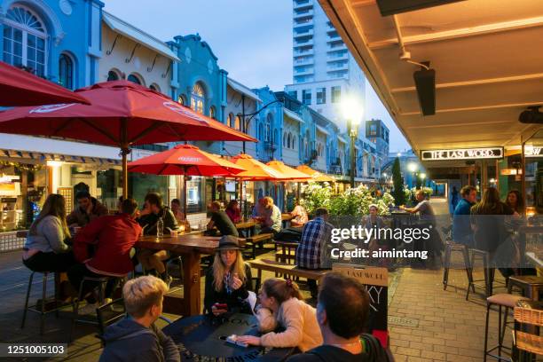 people waiting for dining at new regent street in downtown christchurch - christchurch - new zealand stock pictures, royalty-free photos & images