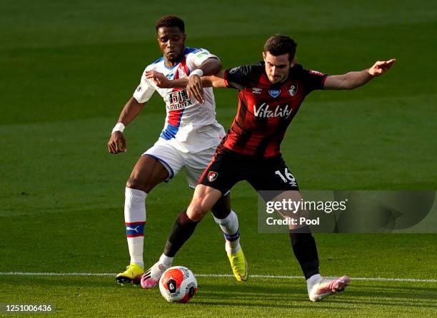 Lewis Cook of AFC Bournemouth battles for possession with Wilfried Zaha of Crystal Palace during the Premier League match between AFC Bournemouth and...