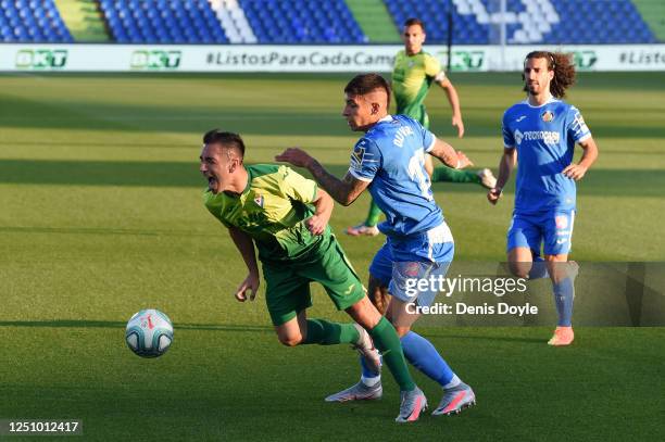 Mathias Olivera of Getafe tackles Charles Dias de Oliveira of Eibar during the La Liga match between Getafe CF and SD Eibar SAD at Coliseum Alfonso...