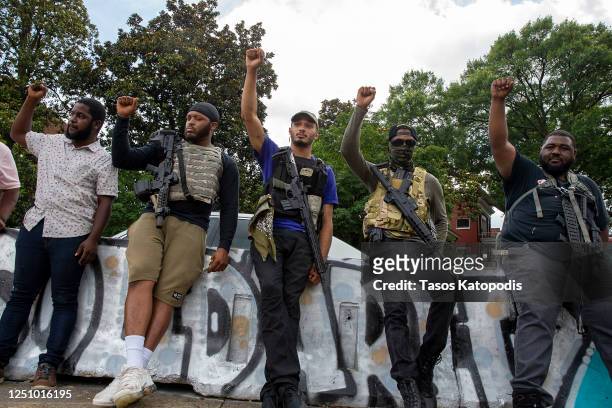 Armed men stand by at the Robert E. Lee Monument on June 20, 2020 in Richmond, Virginia. Richmond Circuit Court Judge Bradley Cavedo ruled on...
