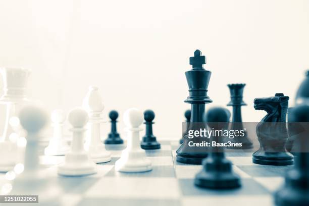 chess pieces on a chessboard - chess pieces stock pictures, royalty-free photos & images