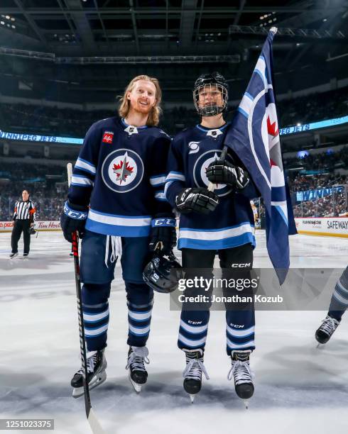 Kyle Connor of the Winnipeg Jets poses with the ScotiaBank Skater prior to puck drop against the Nashville Predators at the Canada Life Centre on...