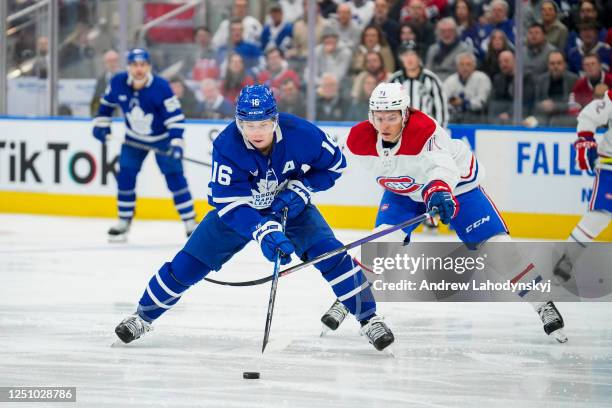 Mitchell Marner of the Toronto Maple Leafs plays the puck against Jake Evans of the Montreal Canadiens during the first period at the Scotiabank...