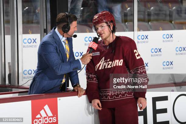Barrett Hayton of the Arizona Coyotes talks with Bally Sports Arizona Color Analyst Tyson Nash after a 5-4 overtime win against the Anaheim Ducks at...