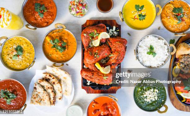 table full of indian food. - indian food stock pictures, royalty-free photos & images