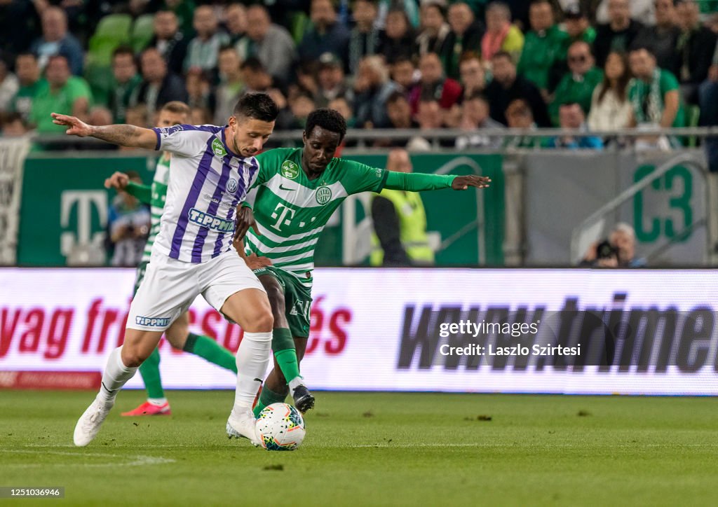 Branko Pauljevic of Ujpest FC competes for the ball with Tokmac