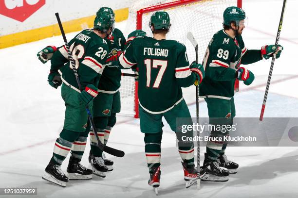 Frederick Gaudreau of the Minnesota Wild celebrates his power play goal against the St. Louis Blues with teammates Gustav Nyquist and Marcus Foligno...