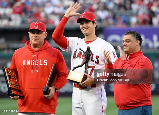 Shohei Ohtani of the Los Angeles Angels waves after being presented the 2022 Edgar Martinez Outstanding Designated Hitter Award by manager Phil Nevin...