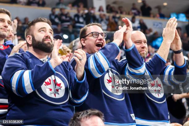 Winnipeg Jets fans stand and cheer during second period action between the Jets and the Nashville Predators at the Canada Life Centre on April 8,...