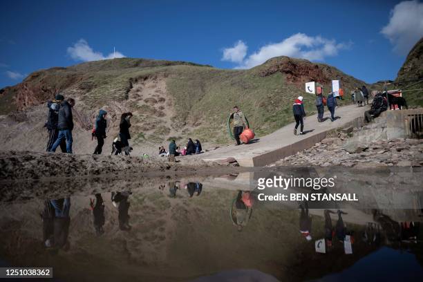 Volunteers arrive to take part in a beach clean organised to collect nurdles and other plastic waste on the Tregantle beach part of the Whitesand...