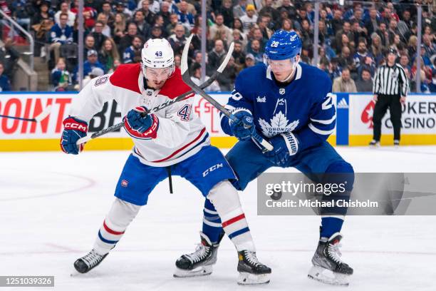 Rafael Harvey-Pinard of the Montreal Canadiens fight for positioning against Sam Lafferty of the Toronto Maple Leafs at the Scotiabank Arena on April...