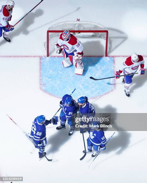 John Tavares of the Toronto Maple Leafs celebrates his goal against the Montreal Canadiens with teammates Erik Gustafsson, Ryan OReilly and Mitchell...