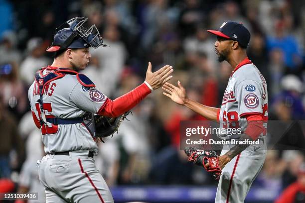 Riley Adams and Carl Edwards Jr. #58 of the Washington Nationals celebrate after defeating the Colorado Rockies at Coors Field on April 8, 2023 in...