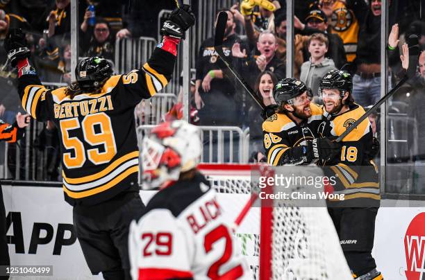 Pavel Zacha of the Boston Bruins celebrates his goal with teammates David Pastrnak and Tyler Bertuzzi in the first period of the game against the New...